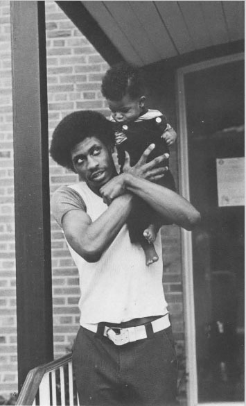 Man with child on shoulder.
