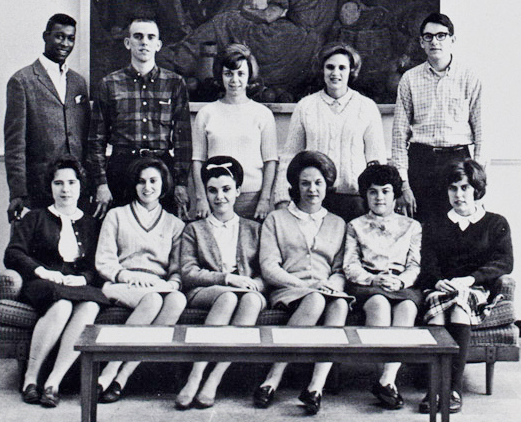 11 mostly white female students posing as a group. Joseph Vaughn, a student who is Black, appears standing in the top left of the photo.